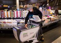 Gina Kaslauskas does her shopping using a new smart cart, part of a pilot project, at a Sobeys grocery store in Oakville, Ont., on Tuesday, November 12, 2019. Shoppers pushing one of 10 new smart carts at a Toronto Sobeys Inc. store can skip the cashier or self-checkout as their carts scan any items put into them, track their total bill and accept payment. THE CANADIAN PRESS/Nathan Denette