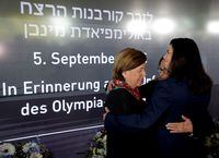 Yael Arad, President of Israeli Olympic committee, Ilana Romano, widow of killed Israeli weightlifter Yossef Romano and Ankie Spitzer, widow of killed Israeli fencing coach Andre Spitzer hug during a ceremony, commemorating the 50th anniversary of the attack on the Israeli team at the 1972 Munich Olympics in which eleven Israelis, a German policeman and five of the Palestinian gunmen died takes place near the Olympic village in Munich, Germany, September 5, 2022.    REUTERS/Leonhard Foeger