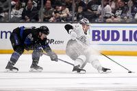 Los Angeles Kings left wing Kevin Fiala, right, falls while under pressure from Toronto Maple Leafs center David Kampf during the third period of an NHL hockey game Saturday, Oct. 29, 2022, in Los Angeles. (AP Photo/Mark J. Terrill)