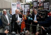 Editor-in-chief of WikiLeaks, Kristinn Hrafnssonon from Iceland, left, and father of Julian Assange, John Shipton, speak to the media in London, Monday, Sept. 7, 2020. Lawyers for WikiLeaks founder Julian Assange and the U.S. government were squaring off in a London court on Monday at a high-stakes extradition case delayed by the coronavirus pandemic. American prosecutors have indicted the 49-year-old Australian on 18 espionage and computer misuse charges over the WikiLeaks publication of secret U.S. military documents a decade ago. The charges carry a maximum sentence of 175 years in prison. (AP Photo/Frank Augstein)