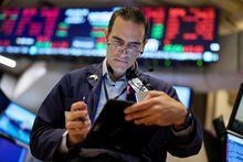 A trader works on the floor of the New York Stock Exchange (NYSE) on Oct. 7.