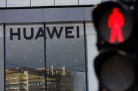 A Huawei sign is seen on its store near a traffic light in Beijing, China July 14, 2020.  REUTERS/Tingshu Wang