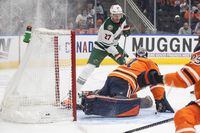 Minnesota Wild's Nick Bjugstad (27) looks for a rebound as the puck goes in past Edmonton Oilers goalie Mike Smith (41) during first period NHL action in Edmonton, Sunday, Feb. 20, 2022. THE CANADIAN PRESS/Jason Franson