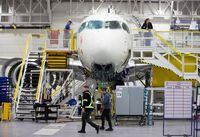 FILE PHOTO: Employees work on an Airbus A220-300 at the Airbus facility in Mirabel, Quebec, Canada February 20, 2020.  REUTERS/Christinne Muschi/File Photo
