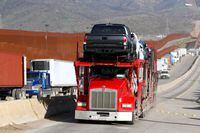 A carrier trailer transports Toyota vehicles for delivery while queuing at the border customs control to cross into the U.S., at the Otay border crossing in Tijuana, Mexico December 11, 2019. REUTERS/Jorge Duenes