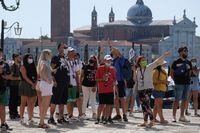 FILE PHOTO: Tourists visit St. Mark's Square in Venice, Italy, September 5, 2021. REUTERS/Manuel Silvestri