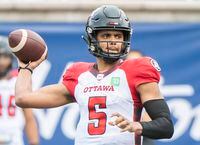 Ottawa Redblacks quarterback Caleb Evans throws a pass during first half CFL football action against the Montreal Alouettes in Montreal, Monday, October 11, 2021. THE CANADIAN PRESS/Graham Hughes