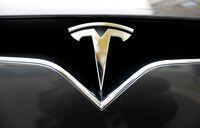 FILE PHOTO: The company logo is pictured on a Tesla Model X electric car in Berlin, Germany, November 13, 2019.    REUTERS/Fabrizio Bensch/File Photo