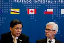 Singapore's Industry and Trade Minister Chan Chun Sing, speaks next to James Carr, Minister of International Trade Diversification of Canada during a meeting of the Comprehensive and Progressive Agreement for Trans-Pacific Partnership, CP TPP, in Santiago, Chile, Thursday, May 16, 2019. (AP Photo/Esteban Felix)