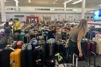  Passengers looks for their luggage among a pile of baggage at arrivals in Pearson airport, in Toronto, Wednesday, June 29, 2022. Yader Guzman/The Globe and Mail