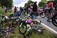 Italy's Kristian Sbaragli, left, and France's Bryan Coquard, right, lie on the ground after crashing during the first stage of the Tour de France cycling race over 197.8 kilometers (122.9 miles) with start in Brest and finish in Landerneau, France, Saturday, June 26, 2021. (Anne-Christine Poujoulat, Pool Photo via AP)