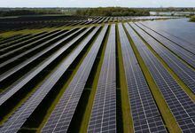 An aerial view shows photovoltaic panels at a solar farm near Thaxted, eastern England, on May 16, 2023. (Photo by Daniel LEAL / AFP) (Photo by DANIEL LEAL/AFP via Getty Images)