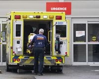 A paramedic loads his stretcher back into the ambulance after bringing a patient to the emergency room at a hospital in Montreal, Thursday, April 14, 2022. Quebec is reporting five more deaths linked to COVID-19 and an 11-patient drop in the number of hospitalizations associated with the disease. THE CANADIAN PRESS/Ryan Remiorz