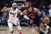 Toronto Raptors guard Gary Trent Jr. (33) drives past Miami Heat guard Gabe Vincent (2) during the first half of an NBA basketball game, Monday, Oct. 24, 2022, in Miami. (AP Photo/Wilfredo Lee)