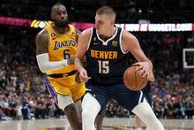 Denver Nuggets center Nikola Jokic (15) backs down Los Angeles Lakers forward LeBron James (6) during the second half of Game 2 of the NBA basketball Western Conference Finals series, Thursday, May 18, 2023, in Denver. (AP Photo/Jack Dempsey)