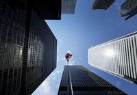 A new report from an advocacy group says that Canada's big banks show "no urgency" in ramping up action against climate change. The Bay Street Financial District is shown with the Canadian flag in Toronto, Friday, Aug. 5, 2022. THE CANADIAN PRESS/Nathan Denette
