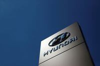 FILE PHOTO: A shop sign of Hyundai is seen outside a car showroom in Bletchley, Milton Keynes, Britain, May 31, 2020. REUTERS/Andrew Boyers