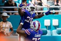 Buffalo Bills running back Devin Singletary (26) is lifted by Buffalo Bills offensive tackle Dion Dawkins (73) after scoring a touchdown during the first half of an NFL football game, Sunday, Sept. 19, 2021, in Miami Gardens, Fla. (AP Photo/Wilfredo Lee)