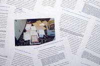 Pages from a Department of Justice court filing on Aug. 30, 2022, in response to a request from the legal team of former President Donald Trump for a special master to review the documents seized during the Aug. 8 search of Mar-a-Lago, are photographed early Wednesday, Aug. 31, 2022. Included in the filing was a FBI photo of documents that were seized during the search. (AP Photo/Jon Elswick)