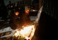 Kirstin Witwicki, right, a cousin of Morgan Harris, joined the family and friends of three slain women at a vigil in Winnipeg, Thursday, Dec. 1, 2022. A landfill has reopened to the public following weeks of conversations between the City of Winnipeg and demonstrators who set up blockades calling for a search of the area for Indigenous women believed to be victims of an alleged serial killer. THE CANADIAN PRESS/John Woods