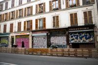 Shuttered stores and boutiques along the Rue Jean Pierre Timbaud in Paris, closed because of France?s lockdown, on Black Friday, Nov. 27, 2020. "Nonessential" stores remain closed until Saturday, so the country has delayed Black Friday a week.  (Sabine Mirlesse/The New York Times) 