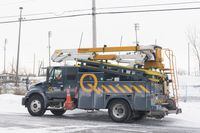 A Hydro Quebec truck is shown in an area without power in Montreal, Saturday, Dec. 24, 2022, following a winter storm in the region.&nbsp;Hydro-Québec is urging people without power to be careful after two deadly fires in the province, both of which are under investigation by provincial police. THE CANADIAN PRESS/Graham Hughes