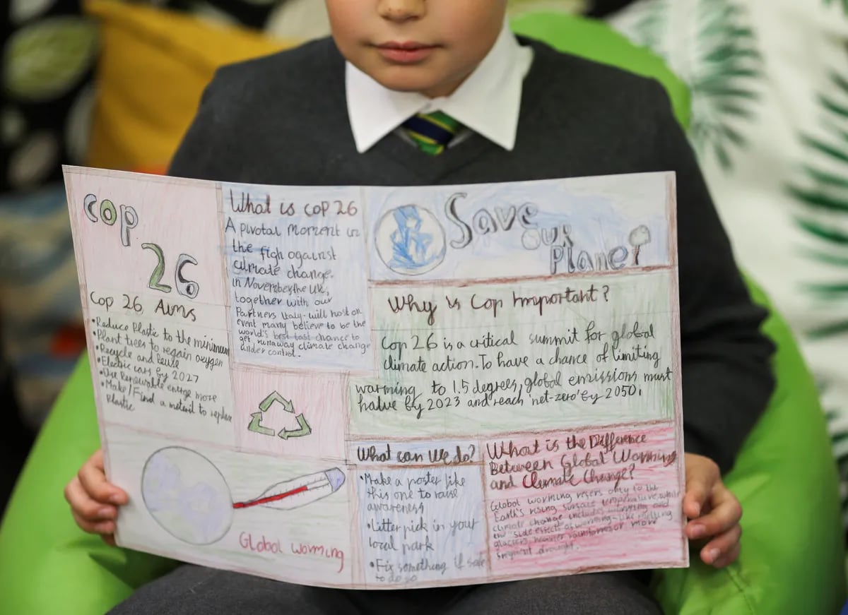 A student holds a poster at St Convals Primary Glasgow while learning about climate change on Oct. 19, 2021