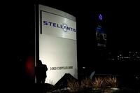 Workers remove the covers on the sign outside of the FCA US LLC Headquarters and Technology Center as it is changed to Stellantis on January 19, 2021 in Auburn Hills, Michigan. - Newly-created European carmaker Stellantis motored its way January 18, 2021 onto the Paris and Milan stock exchanges. Stellantis -- created by the merger of France's PSA and US-Italian rival Fiat Chrysler -- is the world's fourth-biggest automaker by volume. (Photo by JEFF KOWALSKY / AFP) (Photo by JEFF KOWALSKY/AFP via Getty Images)