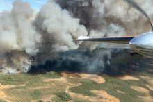 A view of a wildfire over Hay River, Northwest Territories from an air tanker is shown in a May 14, 2023 handout photo. A First Nation reserve and nearby town in the southern Northwest Territories have been evacuated as a wildfire spreads in the area. THE CANADIAN PRESS/HO-Northwest Territories Environment and Natural Resources**MANDATORY CREDIT** 