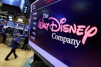 FILE - In this Aug. 8, 2017, file photo, The Walt Disney Co. logo appears on a screen above the floor of the New York Stock Exchange. Nelson Peltz's Trian Fund Management is formally nominating the activist investor and a former Disney executive for a seat on Disney's board, two days after the media and entertainment company nominated a slate of directors that did not include either. Peltz and Jay Rasulo, Disney's former chief financial officer, said in a preliminary proxy filing Thursday, Jan. 18, 2024 that they wanted to complete a successful CEO succession at Disney and align management pay with performance. (AP Photo/Richard Drew, File)
