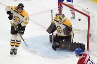 A shot by Montreal Canadiens' Mike Matheson, not seen, enters the net past Boston Bruins' Hampus Lindholm (27) and Linus Ullmark (35) during the second period of an NHL hockey game, Saturday, Jan 20, 2024, in Boston. (AP Photo/Michael Dwyer)