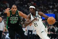 Milwaukee Bucks' Jrue Holiday drives past Boston Celtics' Al Horford during the first half of Game 4 of an NBA  basketball Eastern Conference semifinals playoff series Monday, May 9, 2022, in Milwaukee. (AP Photo/Morry Gash)