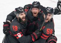 Team Canada defender Maxim Noreau (56) celebrates with teammates Eric Staal (12) and Eric O'Dell (19) after scoring the fourth goal during second period men’s ice hockey action against Germany Thursday, February 10, 2022 at the 2022 Winter Olympics  in Beijing. THE CANADIAN PRESS/Ryan Remiorz