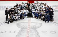 Tampa Bay Lightning players surround NHL Commissioner Gary Bettman as they celebrate after defeating the Dallas Stars to win the Stanley Cup in Edmonton on Sept. 28, 2020.