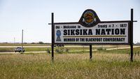 A sign greets people on the Siksika First Nation, east of Calgary near Gliechen, Alta., on June 29, 2021. After 20 years, Siksika Nation has re-instated their self-administered police service after the nation and provincial government successfully brokered a deal with the federal minister of public safety. THE CANADIAN PRESS/Jeff McIntosh