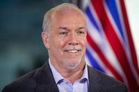 B.C. Premier-elect John Horgan smiles during a post-election news conference, in Vancouver, on Oct. 25, 2020.