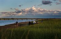 Campers walk along Kelly Beach at sunset in Kouchibouguac National Park, in New Brunswick, on Aug. 17, 2017.