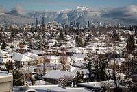 Snow-covered houses and the downtown skyline are seen with the north shore mountains in the distance, in Vancouver, Thursday, December 30, 2021. Canada's latest census shows British Columbia had the second-highest population growth among the provinces, but realtors and buyers say an influx of people has created fiercer-than-ever competition for real estate.THE CANADIAN PRESS/Darryl Dyck