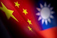 Chinese and Taiwanese printed flags are seen in this illustration taken, April 28, 2022. Picture taken April 28, 2022.  REUTERS/Dado Ruvic/Illustration
