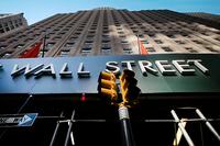 In this May 19, 2021 file photo, a sign for a Wall Street building is shown in New York.