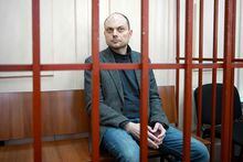 (FILES) In this file photo taken on October 10, 2022 Russian opposition activist Vladimir Kara-Murza sits on a bench inside a defendants' cage during a hearing at the Basmanny court in Moscow. - A Russian prosecutor on April 6, 2023 requested 25 years of imprisonment for Kremlin critic Vladimir Kara-Murza, who is being tried on several charges including treason for comments critical of the Ukraine offensive, his lawyer said. (Photo by NATALIA KOLESNIKOVA / AFP) (Photo by NATALIA KOLESNIKOVA/AFP via Getty Images)