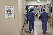TOPSHOT - Healthcare workers walk through the hallway as staff care for patients suffering from coronavirus disease (COVID-19) at Humber River Hospital's Intensive Care Unit, in Toronto, Ontario, Canada, on April 28, 2021. (Photo by Cole Burston / AFP) (Photo by COLE BURSTON/AFP via Getty Images)