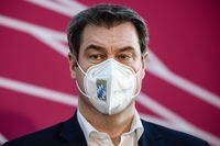 BERLIN, GERMANY - APRIL 11:  State Premier of Bavaria Markus Soeder wears a face mask during a joint press conference on the occasion of a closed door faction meeting of CDU and CSU with party heads Armin Laschet of the CDU and Markus Soeder of the CSU on April 11, 2021 in Berlin, Germany. Analysts see the meeting as an attempt to possibly resolve the question of which of the two men will be the chancellor candidate for the CDU/CSU, the Christian Democratic sister parties that are commonly referred to simply as "the Union" in German politics. Laschet, who is also premier of North Rhine-Wetsphalia, emerged as the favourite within the CDU in a runoff earlier this year, though support for Soeder, who is premier of Bavaria, has grown louder recently as Laschet has faltered in perceived missteps related to coronavirus policy. Merkel is stepping down as chancellor and voters will determine her replacement in federal elections scheduled for September. (Photo by Clemens Bilan - Pool/Getty Images)