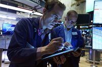 Gregory Rowe, left, works with a fellow trader on the floor of the New York Stock Exchange, Wednesday, Aug. 23, 2023. Wall Street is drifting Wednesday ahead of a profit report that could show whether the frenzy this year around artificial-intelligence technology is deserved or overdone. (AP Photo/Richard Drew)