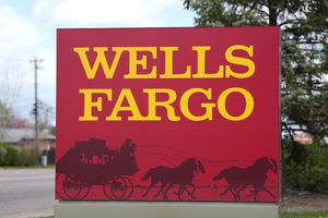 A sign stands outside a branch of Wells Fargo bank Wednesday, April 17, 2024, in Littleton, Colo. (AP Photo/David Zalubowski)