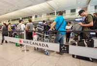 Passengers line up at Trudeau Airport Monday, July 15, 2019 in Montreal.THE CANADIAN PRESS/Ryan Remiorz
