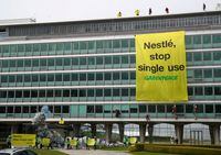 FILE PHOTO: Greenpeace activists demonstrate against plastic usage in front of Nestle headquarters in Vevey, Switzerland April 16, 2019. REUTERS/Denis Balibouse