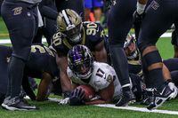Nov 7, 2022; New Orleans, Louisiana, USA; New Orleans Saints defensive end Tanoh Kpassagnon (90) tackles Baltimore Ravens running back Kenyan Drake (17) in the end zone as he makes a touchdown during the second half at Caesars Superdome. Mandatory Credit: Stephen Lew-USA TODAY Sports