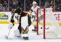 Vancouver Canucks goalie Thatcher Demko allows a goal to Vegas Golden Knights' Reilly Smith, not seen, as Pavel Dorofeyev, back right, watches during the first period of an NHL hockey game in Vancouver, on Tuesday, March 21, 2023. THE CANADIAN PRESS/Darryl Dyck