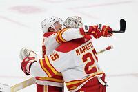 Calgary Flames right wing Tyler Toffoli (73) celebrates with goaltender Jacob Markstrom (25) after Toffoli scored the game winning goal in a shootout against the Minnesota Wild during an NHL hockey game Tuesday, March 7, 2023, in St. Paul, Minn. (AP Photo/Stacy Bengs)